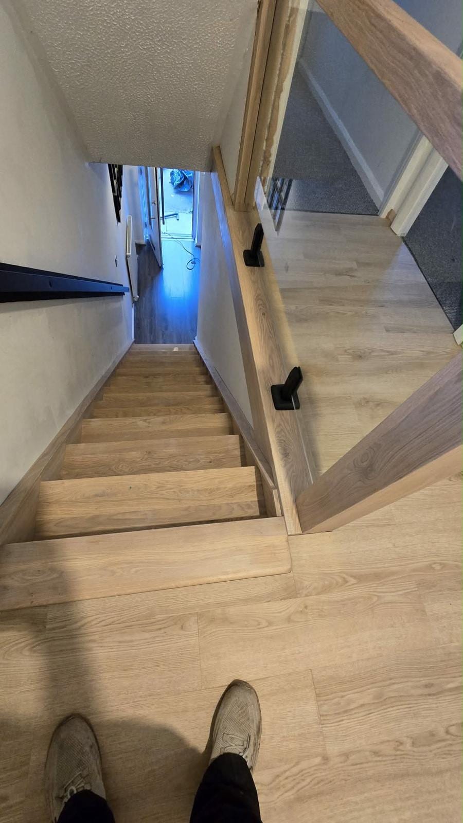 Oak handrail and metal spindle balustrade viewed from below the stairs