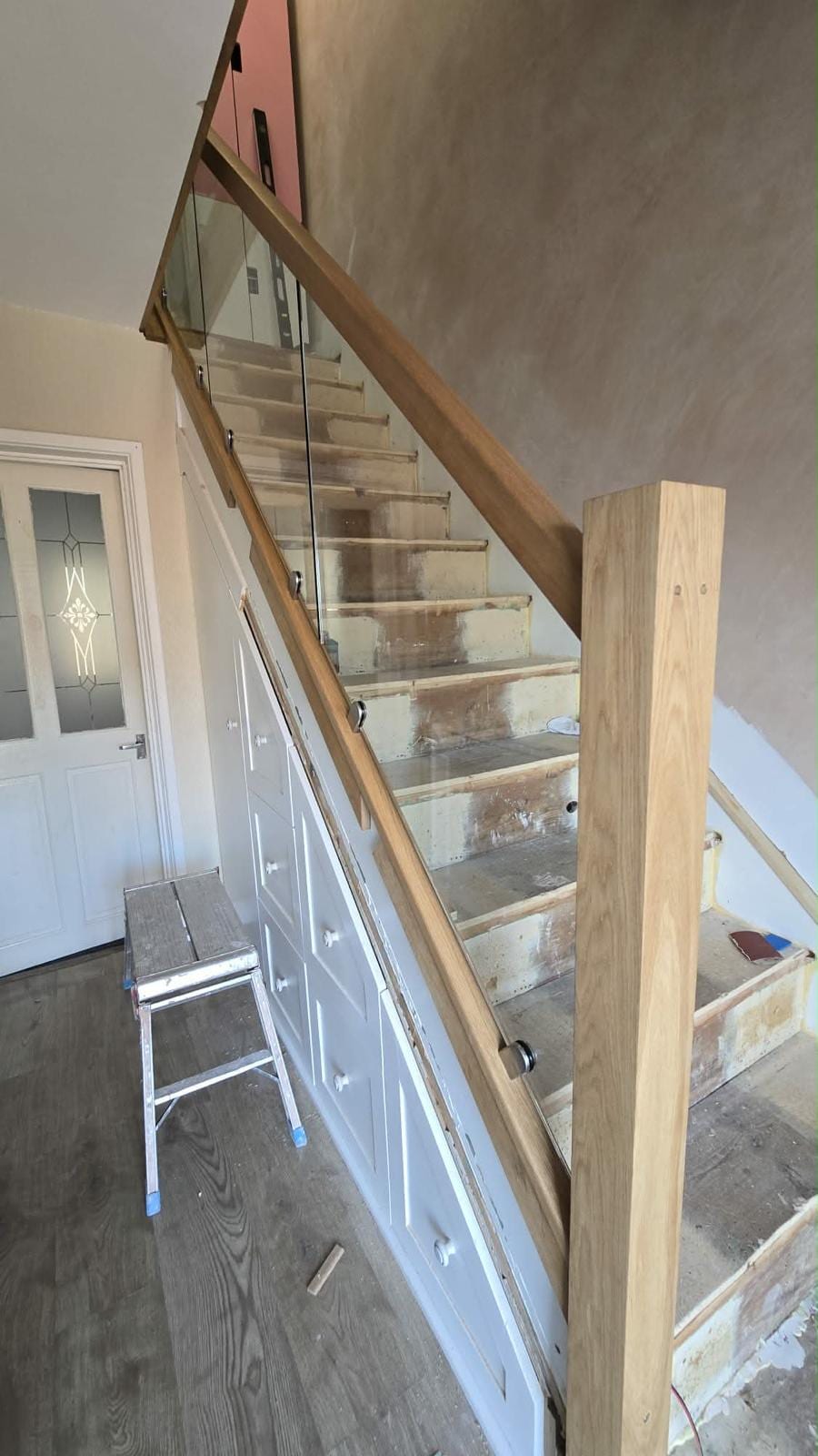 Oak newel post and balustrade detail on a bespoke staircase