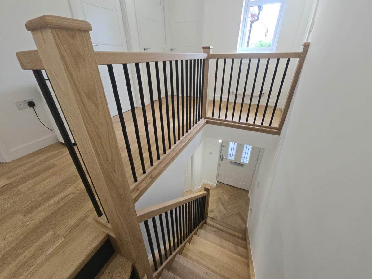 Glass panel balustrade with an oak handrail fitted to a staircase