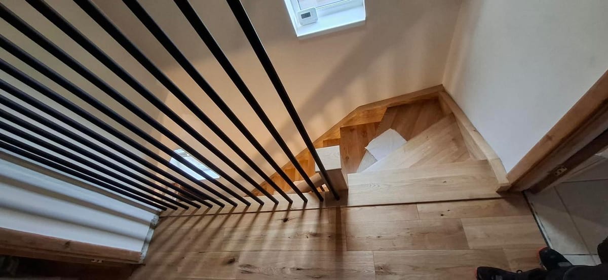Oak newel post and balustrade detail on a bespoke staircase