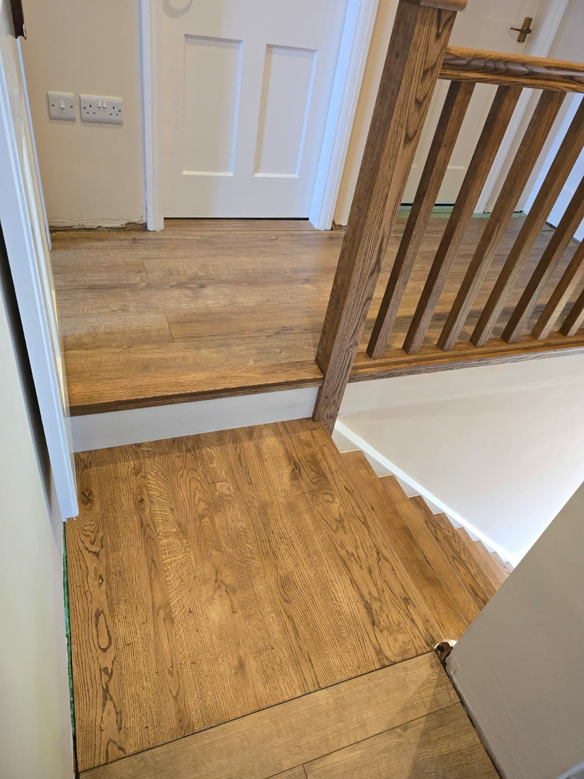 Close-up of an oak handrail joint on a fitted balustrade
