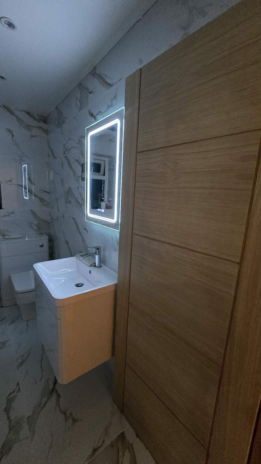 Tiled bathroom with a walk-in glass shower screen