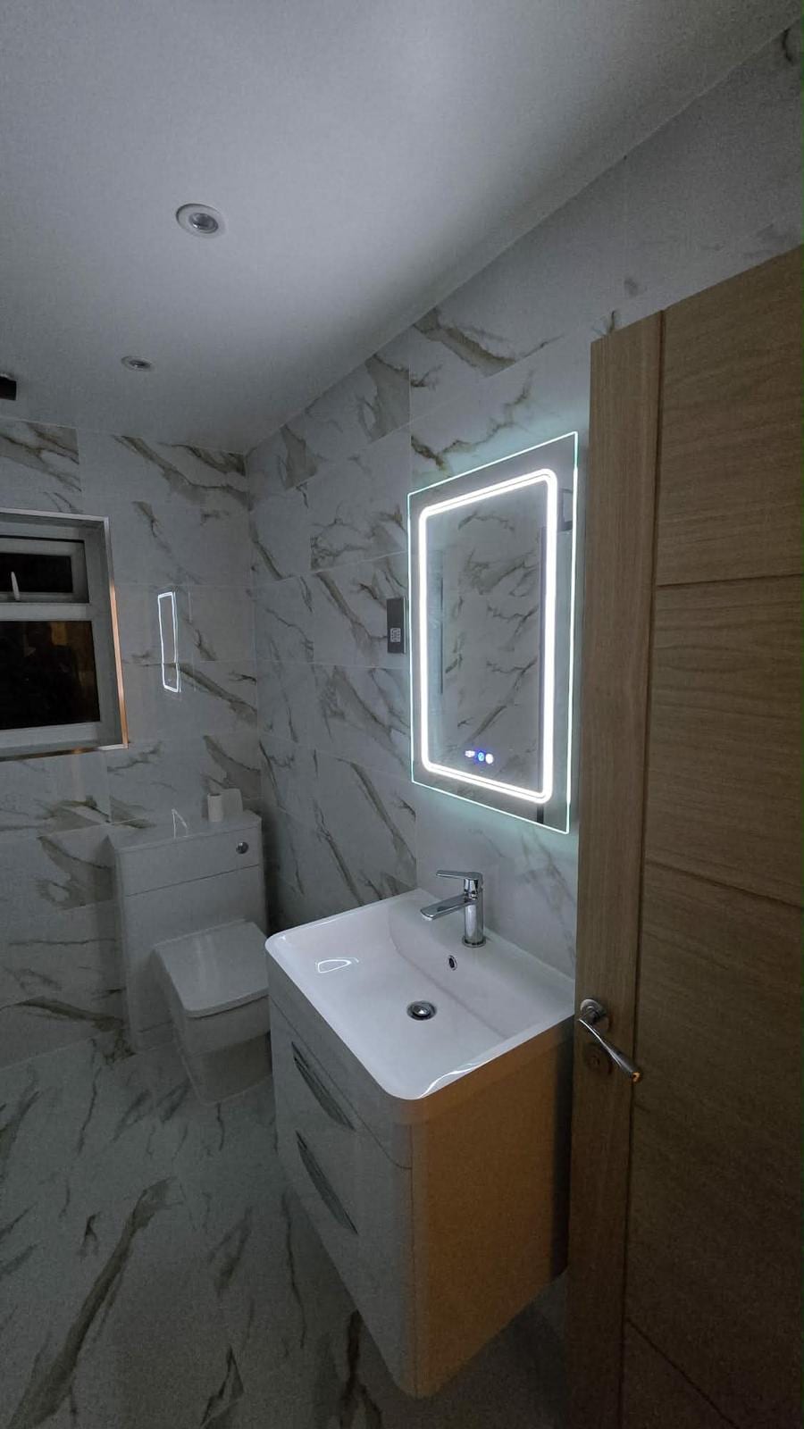 Bathroom renovation with a fitted vanity sink and heated towel rail