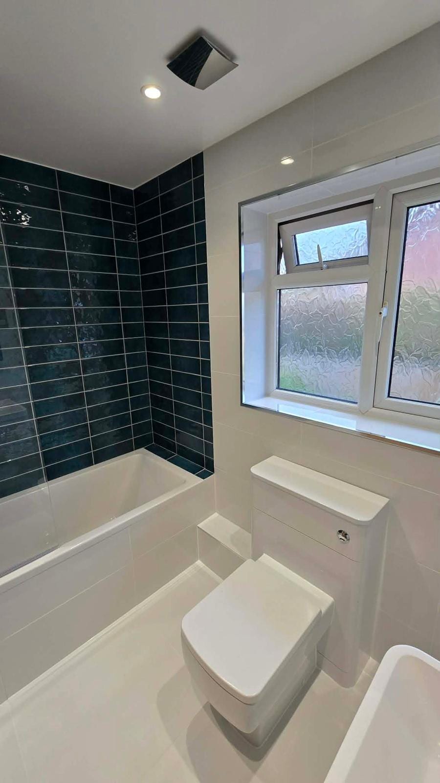 Newly tiled bathroom fit-out with fitted storage