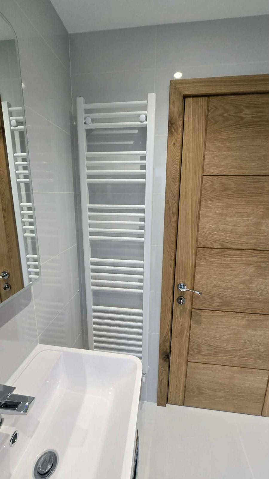 Full bathroom fit-out with a marble-effect tiled shower enclosure