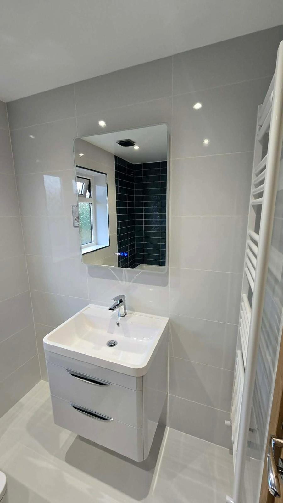 Complete bathroom fit-out with bespoke vanity unit and fitted mirror