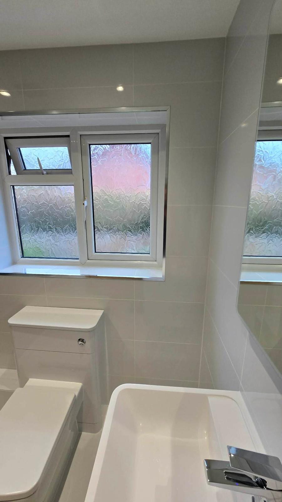 Tiled bathroom with a walk-in glass shower screen