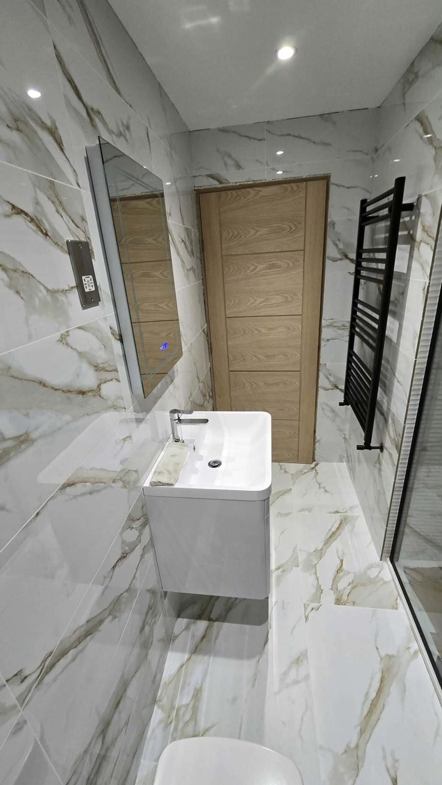 Complete bathroom fit-out with bespoke vanity unit and fitted mirror