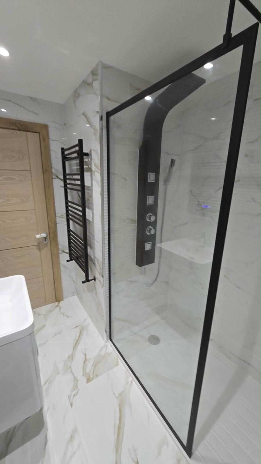 Tiled bathroom with a walk-in glass shower screen