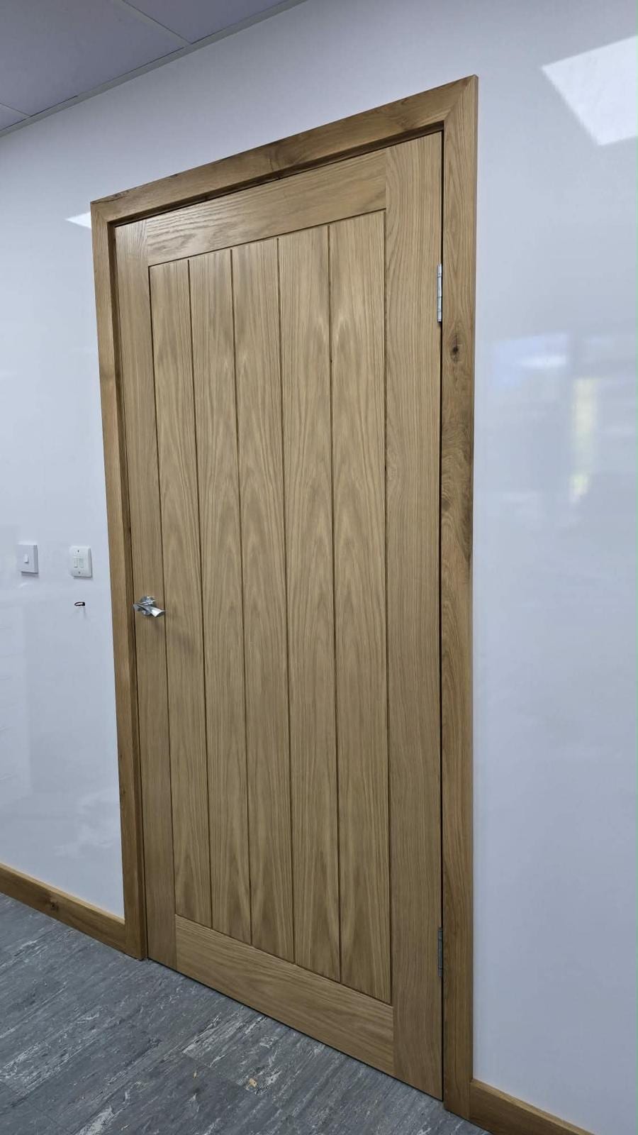 Oak door frame with matching skirting fitted in a renovated room