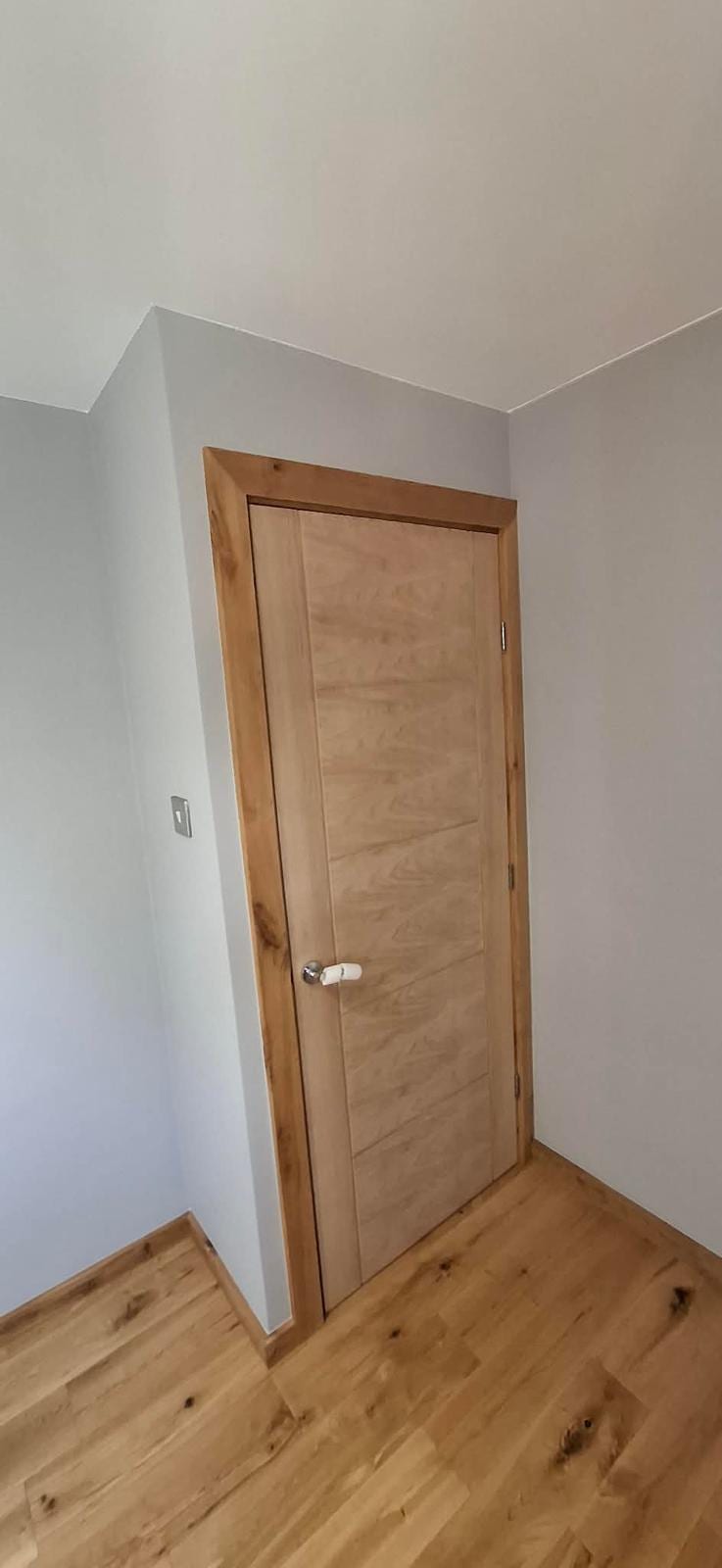 Close-up of an oak door frame joint and architrave detail
