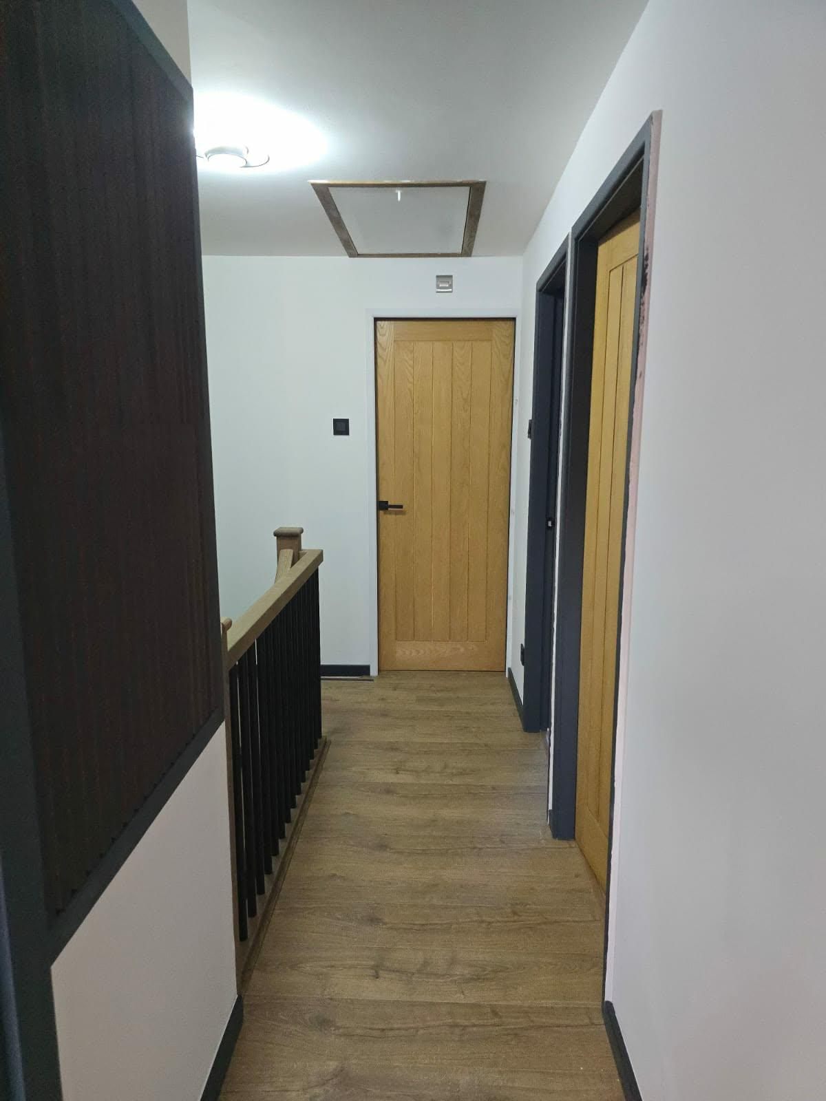 Oak-effect laminate flooring fitted along an upstairs hallway landing