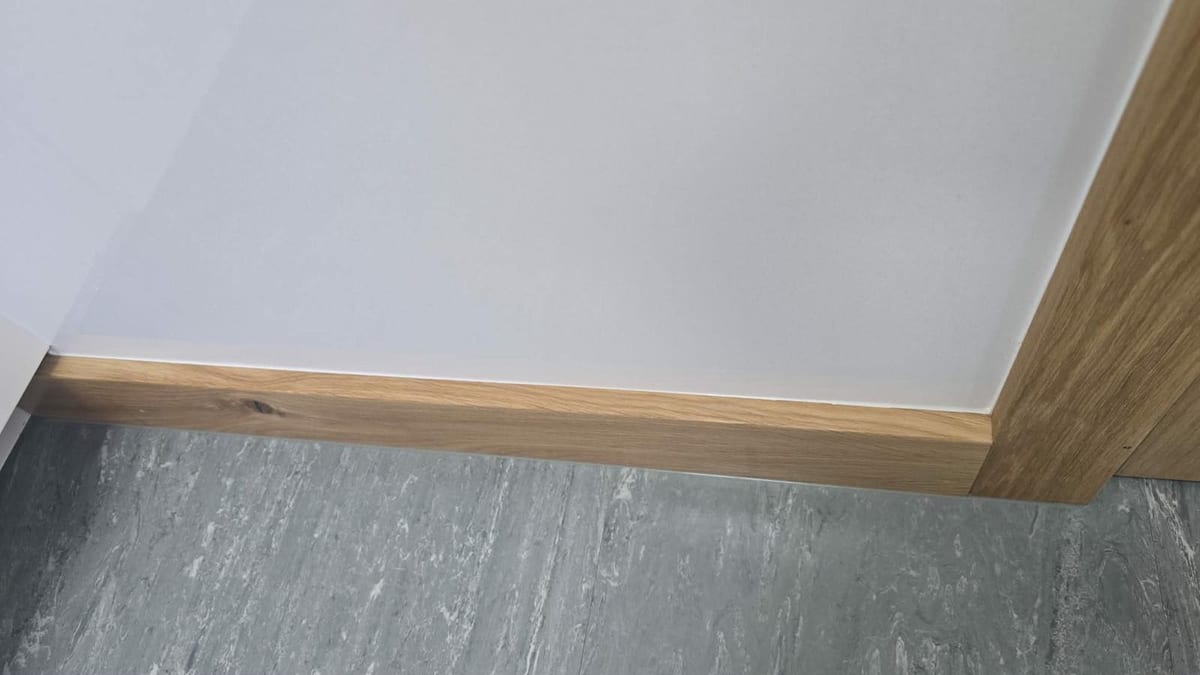 Solid oak skirting board fitted along a hallway floor