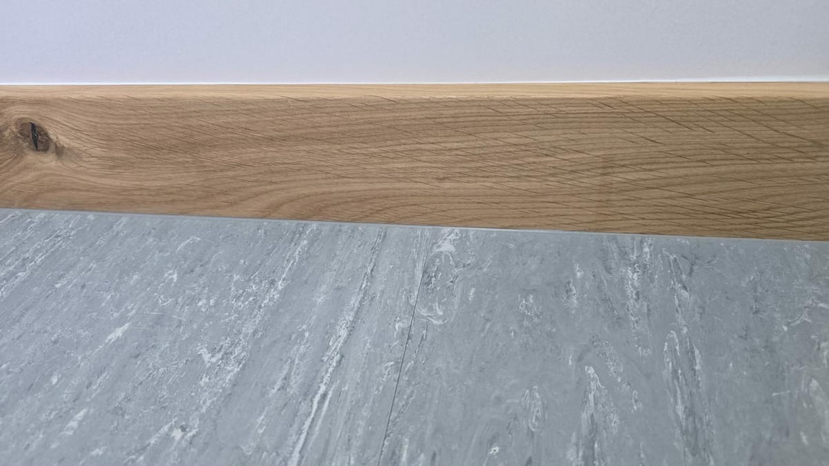 Close-up of an oak skirting board profile and mitred corner