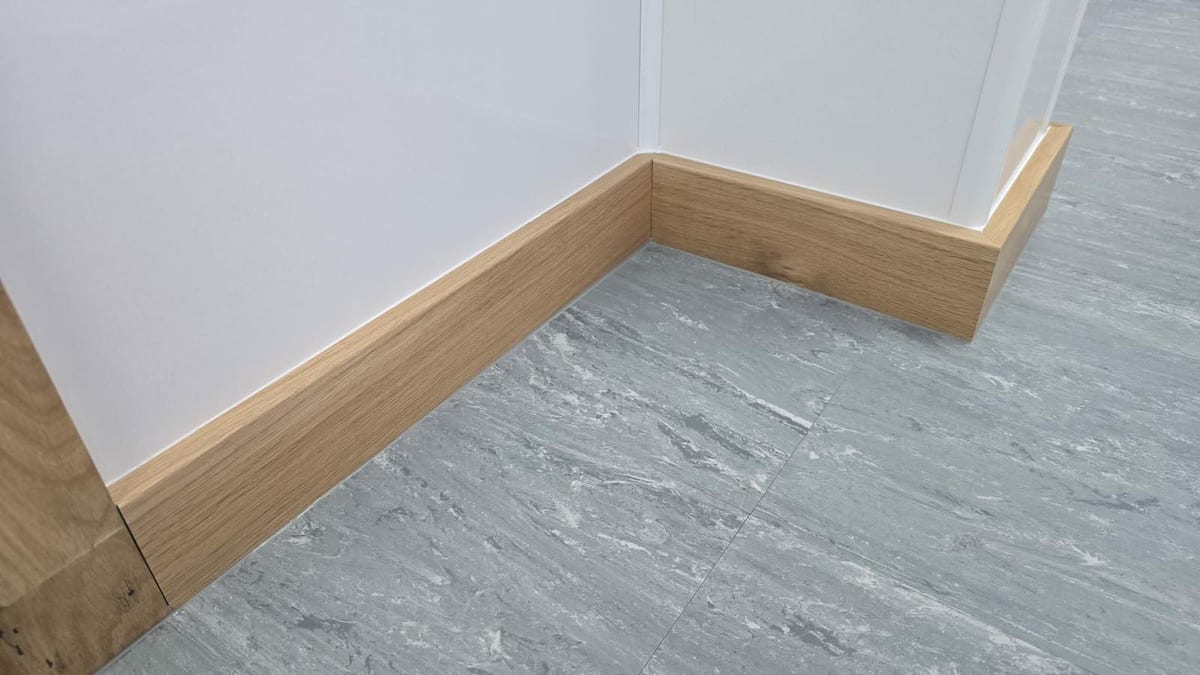 Solid oak skirting board fitted along a hallway floor