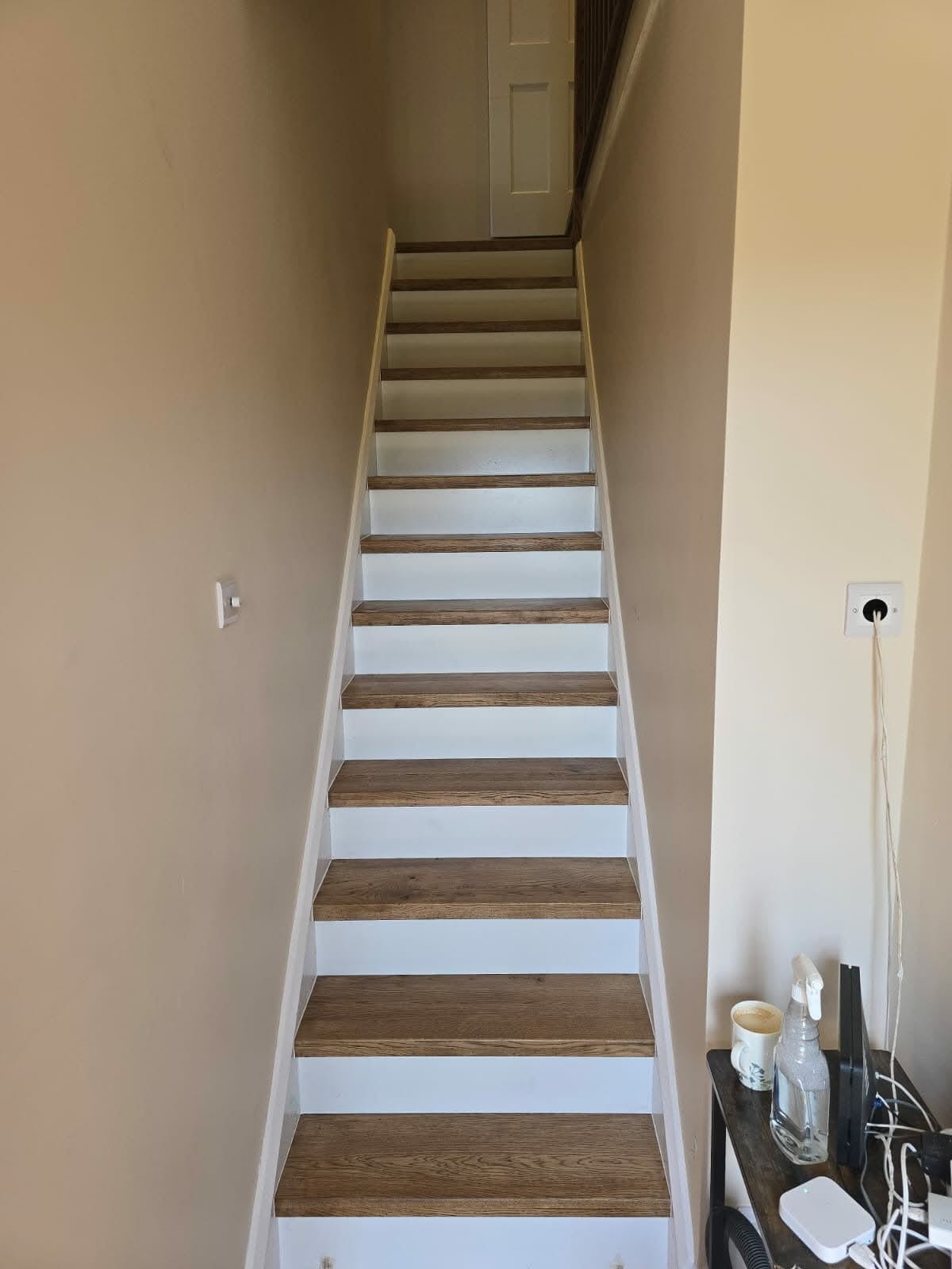 Close-up of oak stair tread grain and nosing detail on a completed overlay