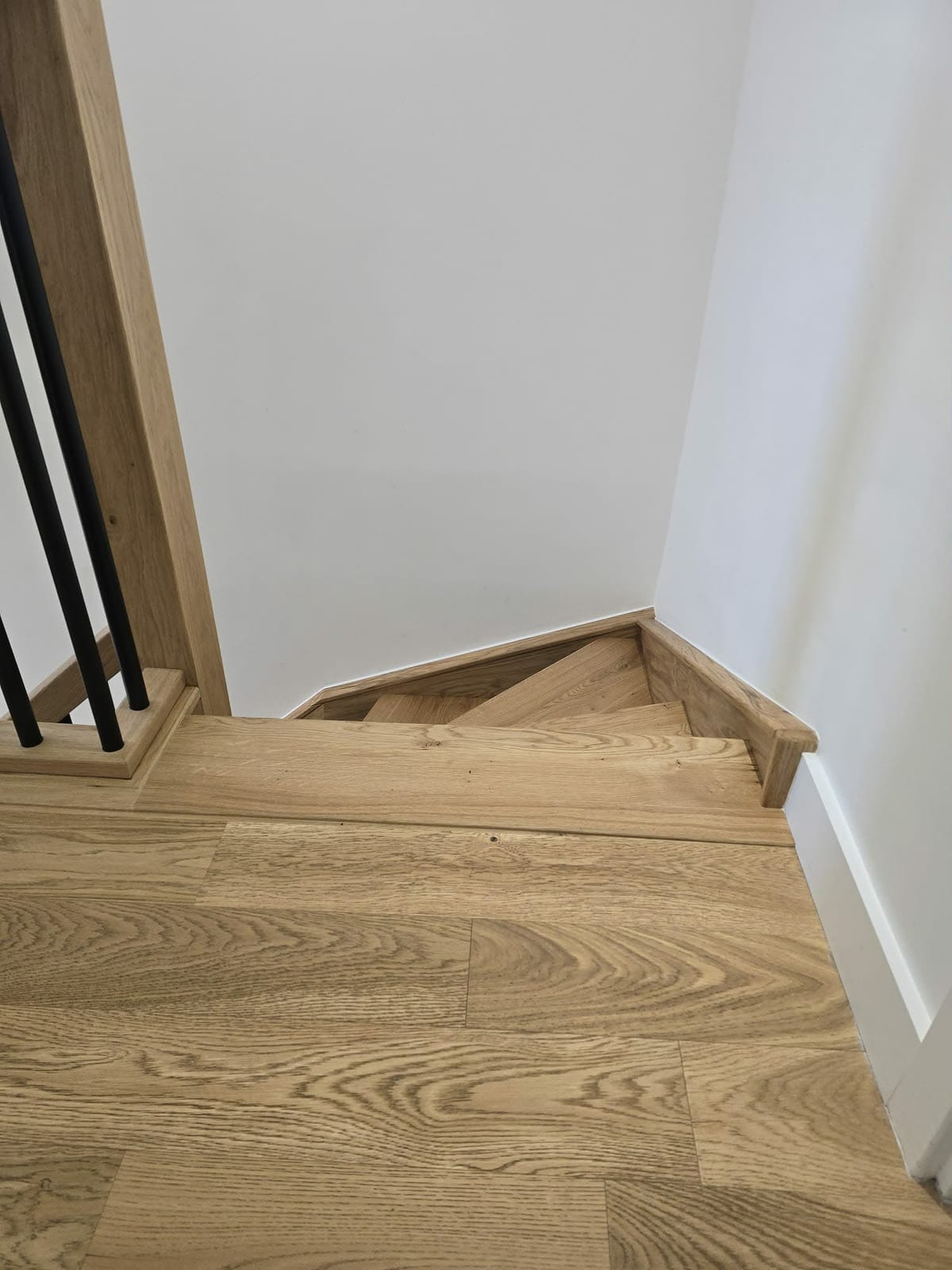 Turning staircase fitted with solid oak overlay and glass balustrade panel