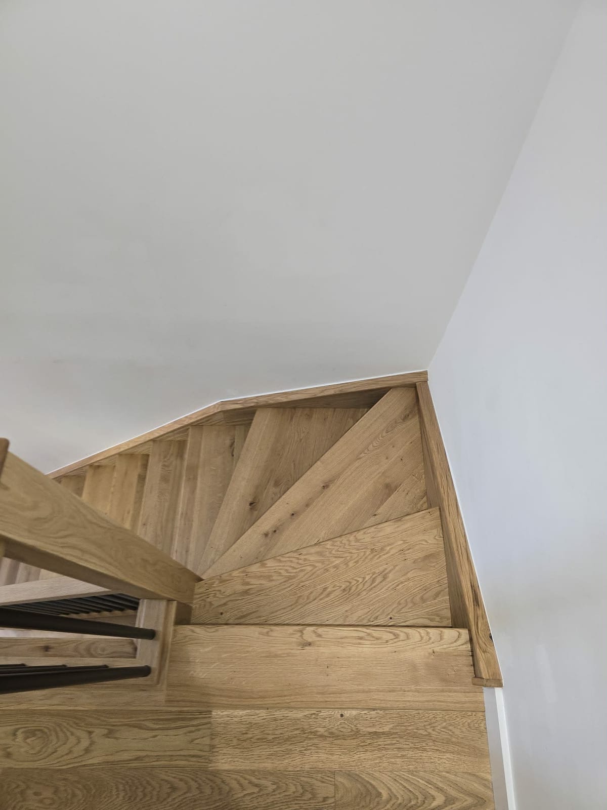 Oak staircase overlay and matching skirting fitted in a hallway renovation