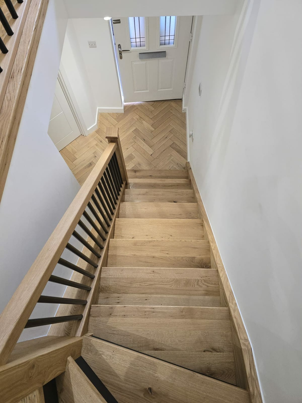 Close-up of oak stair tread grain and nosing detail on a completed overlay