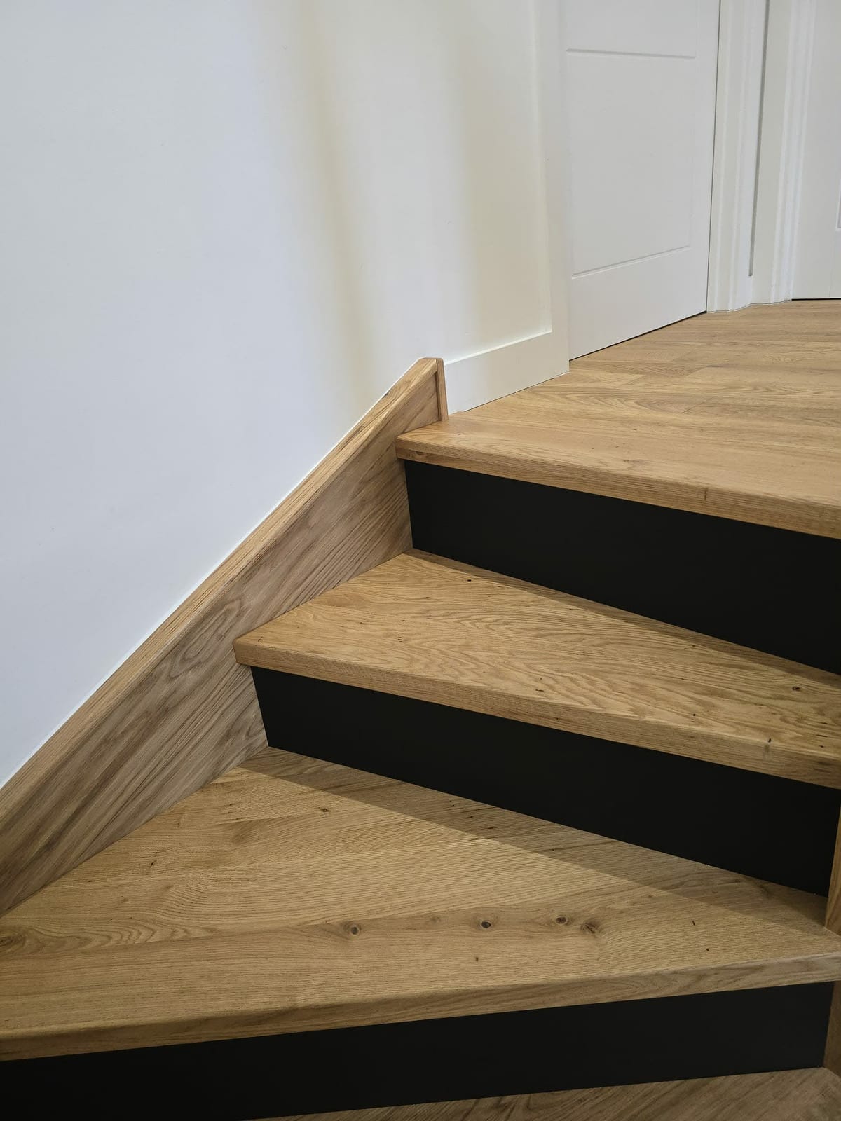 Turning staircase fitted with solid oak overlay and glass balustrade panel