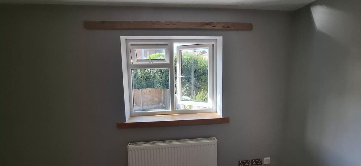Oak window sill fitted beneath a double-glazed unit
